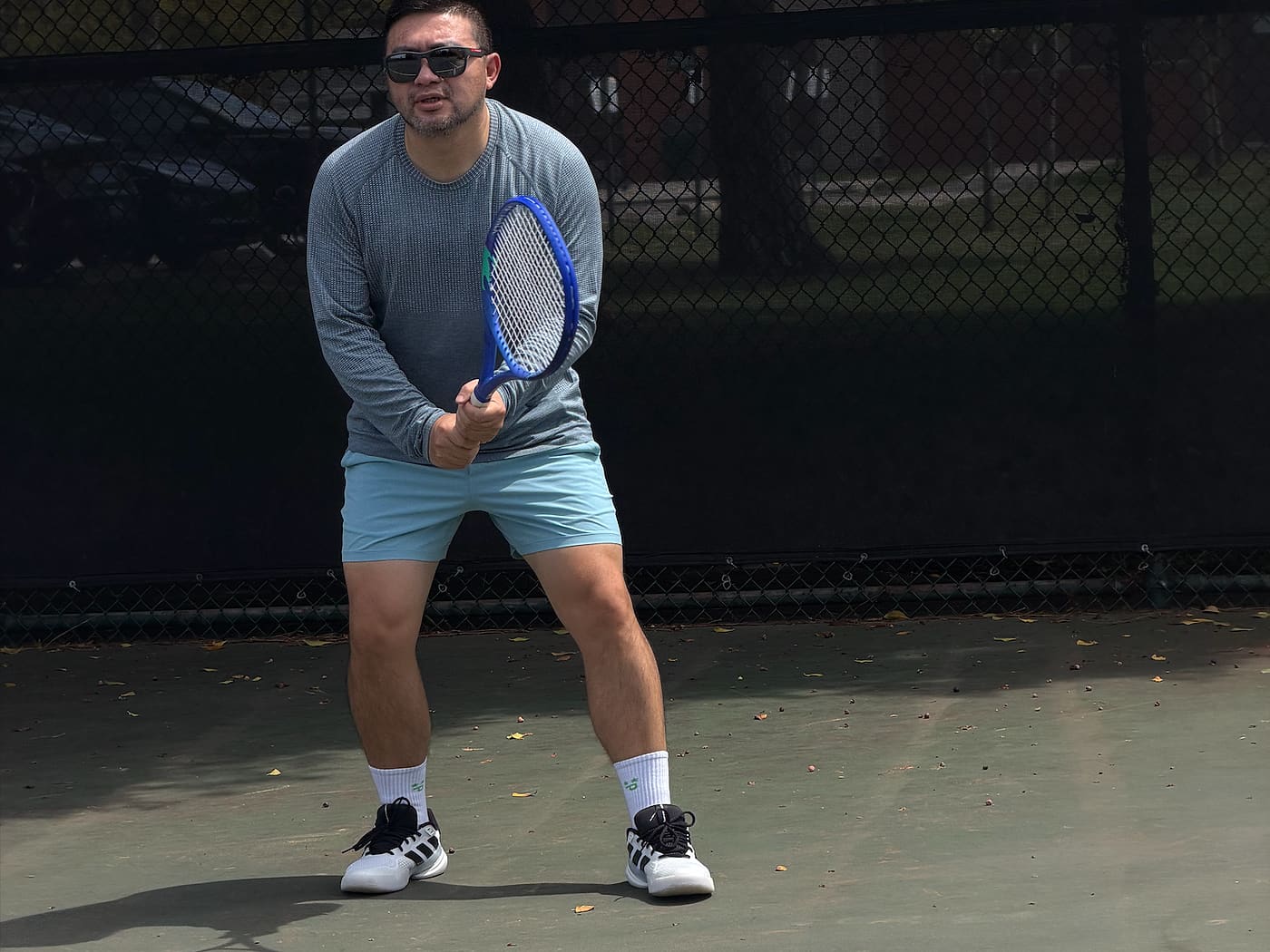 An adult player in the ready position during a private tennis lesson in the Los Angeles area