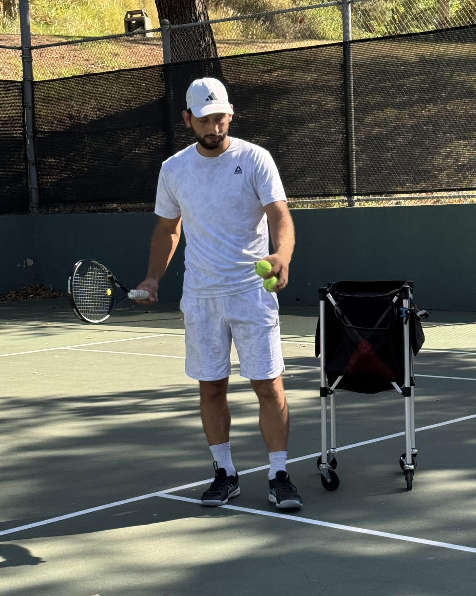 Hayk, junior development tennis coach in Pasadena, coaching a young player