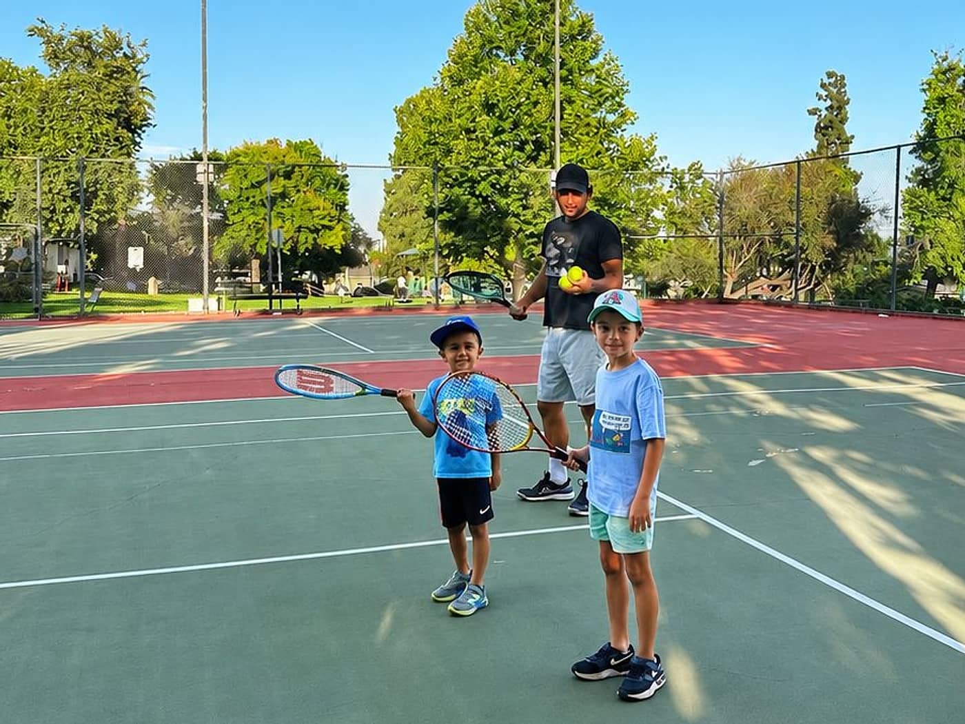 Hayk running a kids tennis lesson on court in the Pasadena area