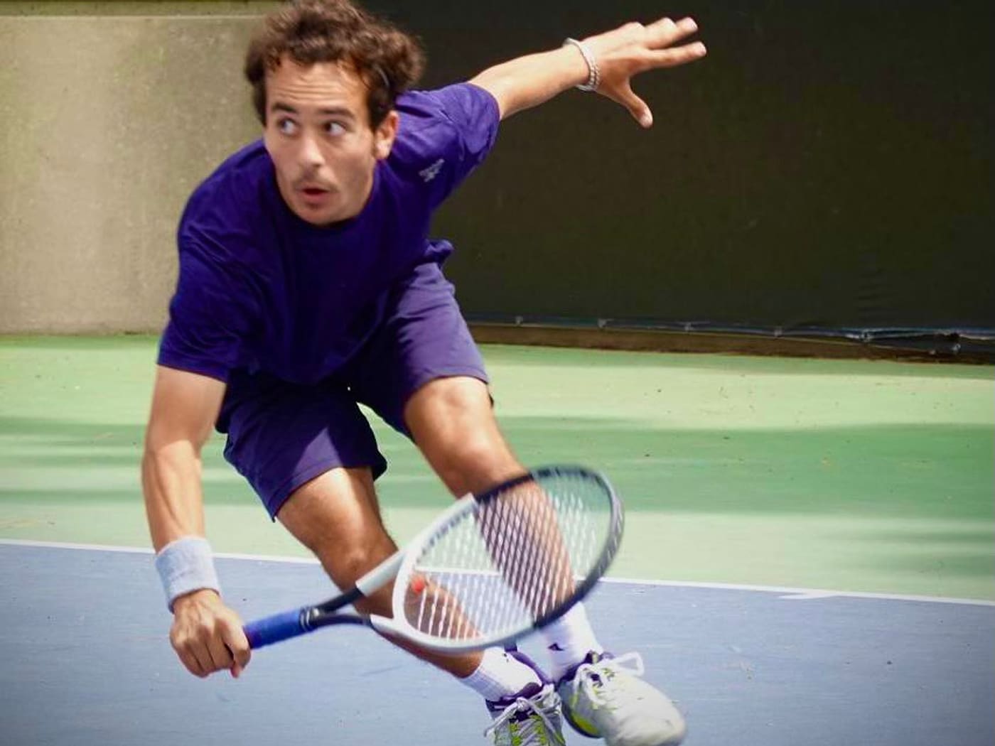 Markos Mkrtchyan stretching for a volley during match play — private tennis lessons in Pasadena