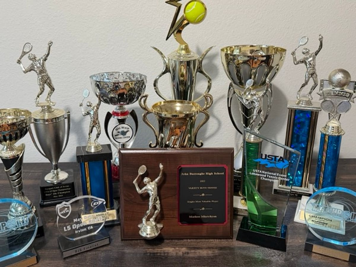 Junior tournament trophies won by coach Markos Mkrtchyan — competitive tennis training in Los Angeles